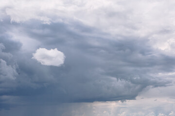 Beautiful clouds in the sky. Large clouds floating in the sky and one small cloud