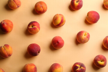 Fresh ripe peaches on beige background, flat lay