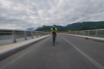 triathlon athlete riding a bike on morning training