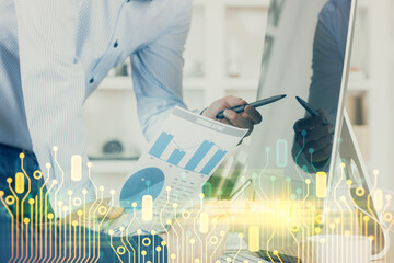 Multi exposure of tech drawings with man working on computer background. Concept of innovation.