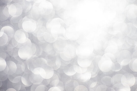 Silver white glittering Christmas lights. Blurred abstract background
