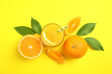 Glass of orange juice and fresh fruits on yellow background, flat lay