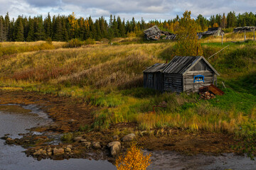 wooden old house on the river, far outside the city, Murmansk region in autumn, copyspace, landscape