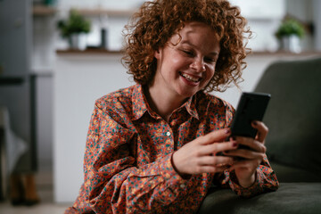 Young woman using the phone. Beautiful woman having video call.