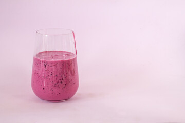 smoothies of berries and cornflakes on a pink background