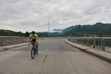 Fototapeta na wymiar triathlon athlete riding a bike on morning training
