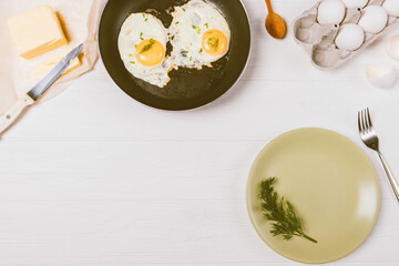Homemade breakfast of fried eggs among ingredients