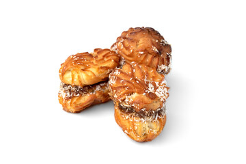 Profiteroles with condensed milk isolated on white background.