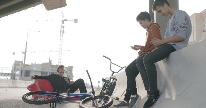 Tired bored friends with bikes - Powered by Adobe