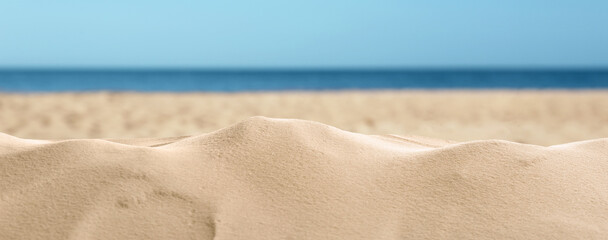 Beautiful beach with golden sand near sea, closeup view. Banner design