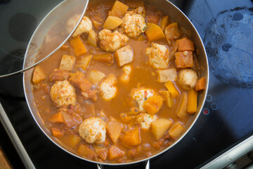 Traditional pumpkin Kubbe soup, a famous middle eastern dumplings soup dish, boiled in a pot