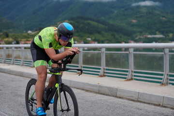 triathlon athlete riding a bike on morning training