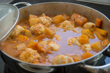 Traditional pumpkin Kubbe soup, a famous middle eastern dumplings soup dish, boiled in a pot