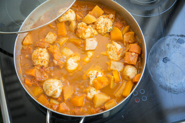 Traditional pumpkin Kubbe soup, a famous middle eastern dumplings soup dish, boiled in a pot