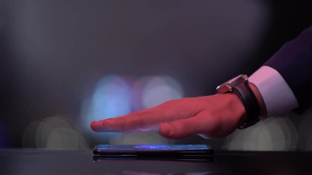 Hand over Phone Reveals Hologram Word REAL ESTATE