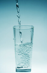 Glass of pouring water