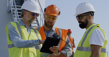 Builders discussing power plant construction