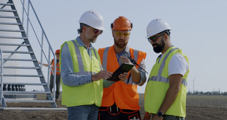 Builders discussing power plant construction