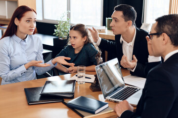 Mom speaks with a lawyer who sits across from her.