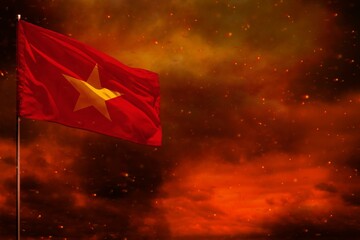 Fluttering Vietnam flag mockup with blank space for your text on crimson red sky with smoke pillars...