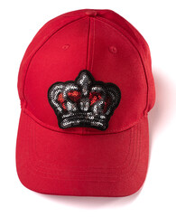 Red cap with a sequin crown patch on white background