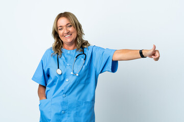 Middle aged surgeon woman over isolated background giving a thumbs up gesture