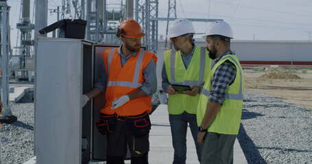 Engineer showing power transformer to inspectors