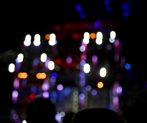 Bokeh from the light from the stage of a rock concert.