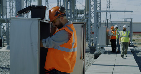 Engineer showing power transformer to inspectors