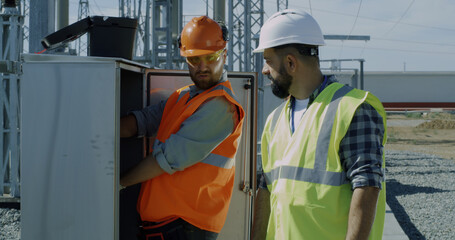 Engineer showing power transformer to inspectors
