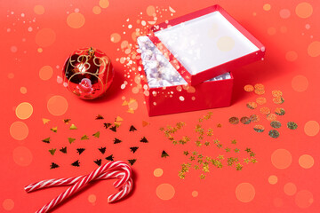 Christmas and new year composition on red background with gift box and ball.
