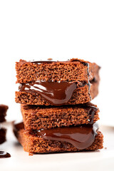 Tasty homemade chocolate cake with chocolate filling on a white background close-up. Free space for text. Stack of chocolate brownies. Sweet food, homemade cakes. Copy space.