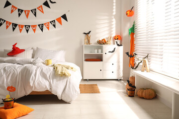 Stylish bedroom interior with festive Halloween decor