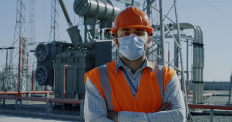 Mature foreman crossing arms on power plant