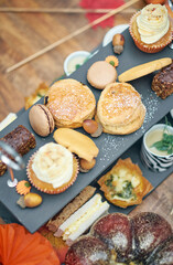 A beautiful gourmet selection of english afternoon tea cakes and scones served with organic...