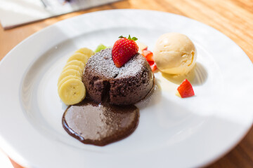 A dessert dish call chocolate lava, include vanilla ice cream, banana, kiwi and apple. This sweet is made from cocoa seed. Good combination between chocolate cake, cold ice cream and fruits.