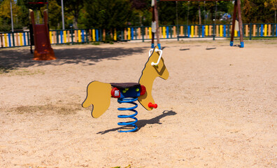 Top angle of a child's horse swing in an empty playground