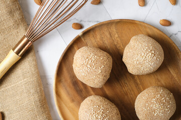 Gluten free Keto bread. Homemade ketogenic buns with sesame seeds. set on white cafe table.