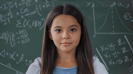 joyful schoolkid looking at camera near chalkboard - Powered by Adobe