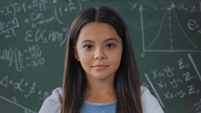 joyful schoolkid looking at camera near chalkboard - Powered by Adobe