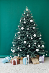 Christmas tree pine Christmas decoration interior of the green room with holiday postcard gifts