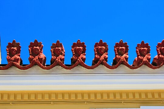 Decorative elements on the rooftop of a neoclassical house, in the traditional neighborhood of Plaka in Athens, Greece.
