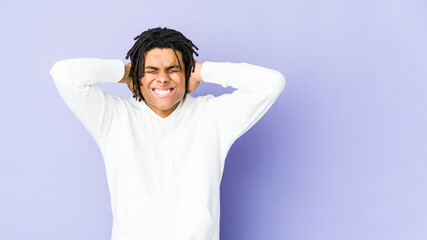 Young african american rasta man covering ears with hands trying not to hear too loud sound.