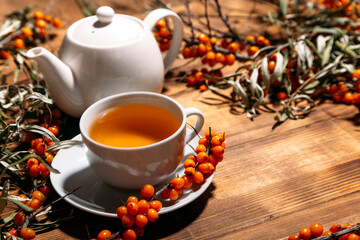 tea with sea buckthorn on a wooden background