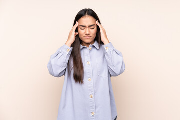 Young Indian woman isolated on beige background with headache