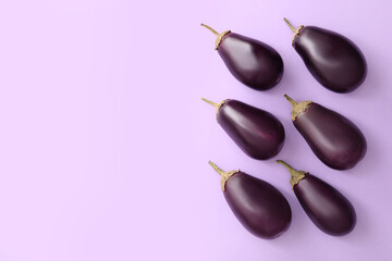 Raw ripe eggplants on light background, flat lay. Space for text