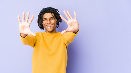 Young black man wearing rasta hairstyle showing number ten with hands.