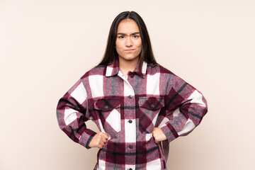 Young Indian woman isolated on beige background angry