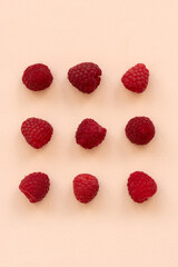 Fresh raspberries on pink background. Top view. Flat lay