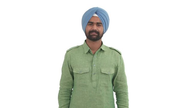Indian beard man in dastar making Namaste gesture with slight bow. Hindu greeting. Isolated on white background